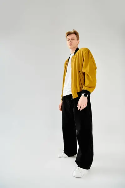 A stylish young man confidently displays his fashion in a modern setting. — Stock Photo