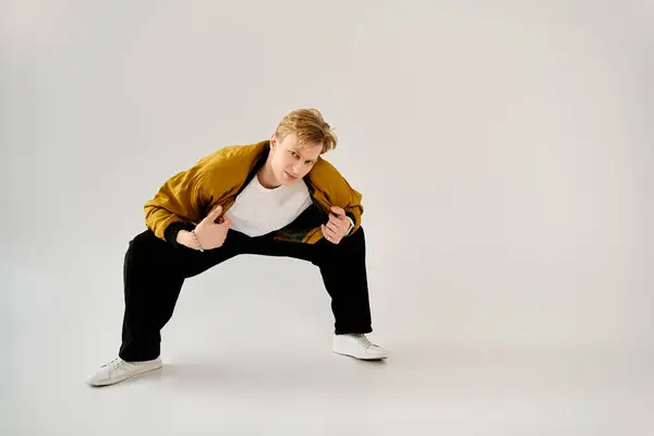 A young man showcases his unique style while confidently posing in casual attire. — Stock Photo