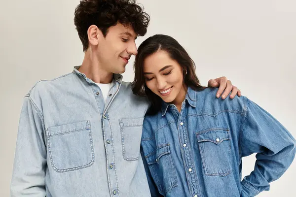 Two young individuals enjoy a heartfelt connection while dressed in stylish denim apparel. — Stock Photo