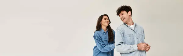 Two young friends in stylish denim share a joyful moment, showcasing their friendship. — Stock Photo