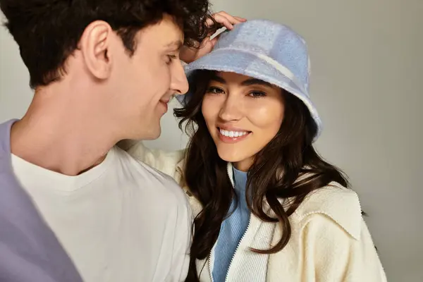 Two fashionable young individuals share a lighthearted moment, showcasing trendy styles. — Stock Photo