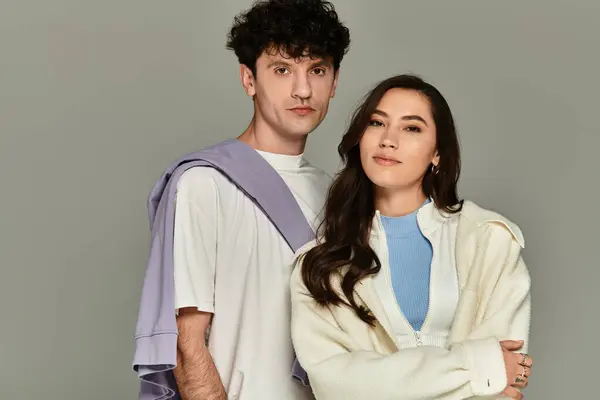 Two young individuals display their fashionable outfits while posing confidently together. — Stock Photo