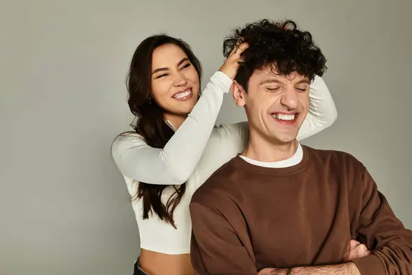 Two young friends share a joyful moment featuring modern styles and expressions of affection. — Stock Photo