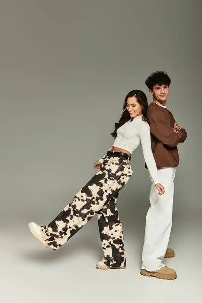 A fashionable duo showcases their unique styles in a chic, modern setting. — Stock Photo