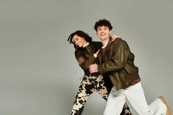 Two stylish individuals share a joyful moment, flaunting their trendy outfits and energy. — Stock Photo