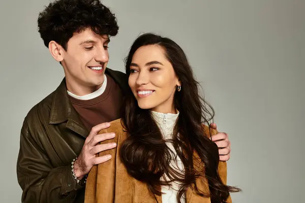 A fashionable pair enjoys each others company, radiating happiness in a charming studio. — Stock Photo