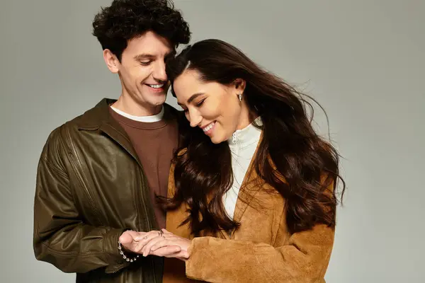 Young, fashionable couple engaging in a playful, loving interaction, radiating style and joy. — Stock Photo