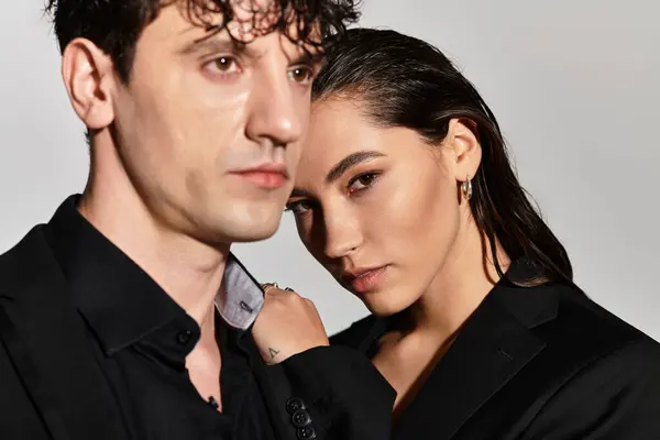 A trendy young duo showcases their fashion forward looks, exuding charisma and elegance. — Stock Photo