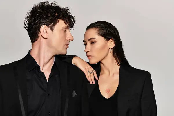 Two young adults showcase their bold fashion choices in an edgy studio environment. — Stock Photo