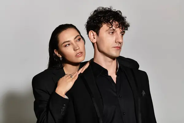 In a contemporary setting, a fashionable duo showcases striking styles while posing close together. — Stock Photo