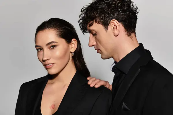Deux figures branchées mettent en valeur des styles de mode modernes avec des poses élégantes sur fond neutre. — Photo de stock