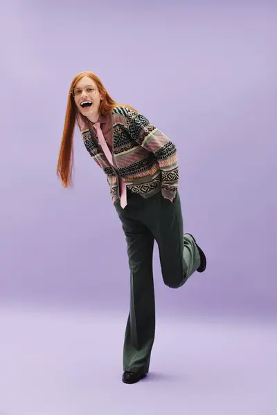 Young man exudes confidence and style with long red hair, playful posture, and fashionable outfit. — Stock Photo