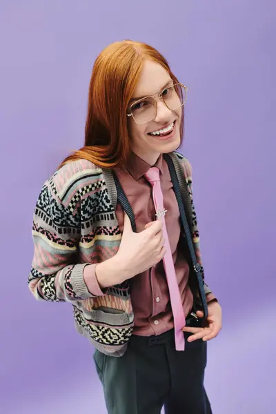 A confident young queer man with long red hair showcases his fashionable style in vibrant attire. — Stock Photo