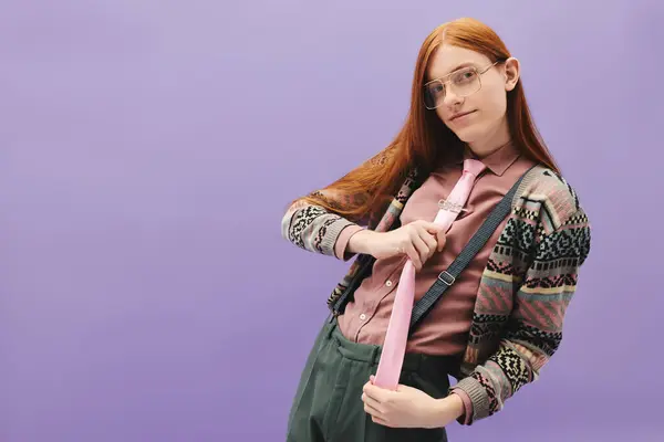 A young man with long red hair showcases a stylish outfit against a colorful backdrop. — Stock Photo