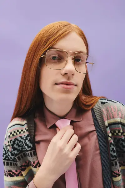 A confident young man with long red hair wears stylish glasses and fashionable clothing. — Stock Photo