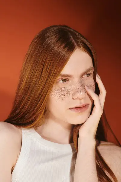 A handsome young man with striking red hair and freckles poses thoughtfully, embodying modern style. — Stock Photo