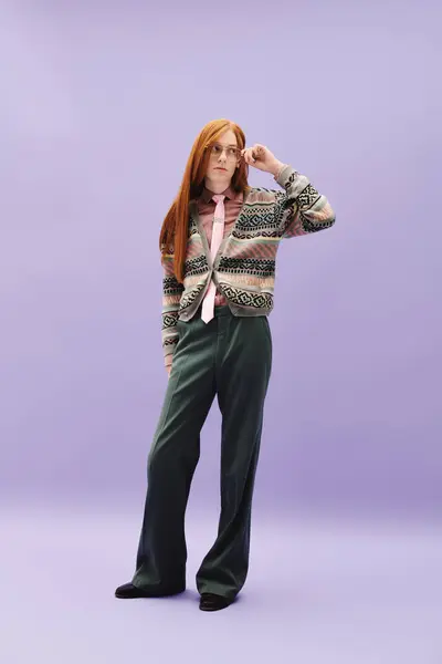 A queer young man with long red hair showcases his fashionable outfit in a creative setting. — Stock Photo