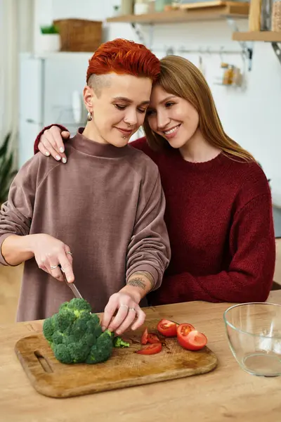 Two beautiful young women share a loving moment while preparing a healthy meal together. — Stock Photo