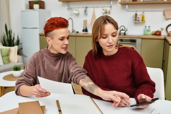 Two beautiful young women share a joyful moment while exploring ideas together. — Stock Photo