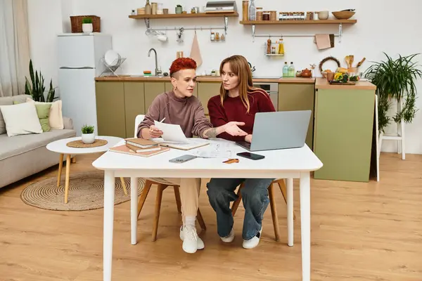 A beautiful young couple engages in a conversation while working at home. — Stock Photo