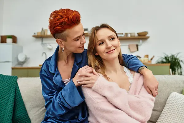 Two young women share a loving embrace, enjoying a peaceful afternoon at home together. — Stock Photo