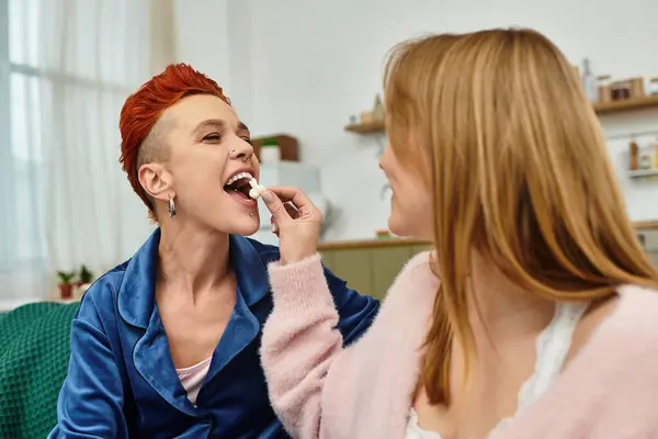 Two young women share a joyful moment together at home, enjoying each others company and laughter. — Stock Photo