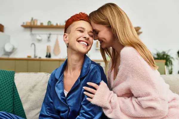 Two young women enjoying each others company at home, sharing laughter and love. — Fotografia de Stock