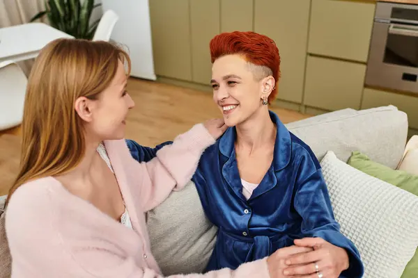 Two beautiful women in a cozy modern apartment enjoy a loving moment together. — Stock Photo
