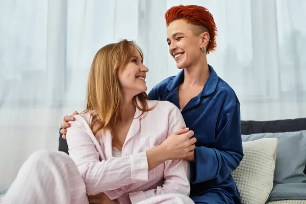 Two beautiful women enjoy each others company in their cozy bedroom, radiating love and happiness. — Stock Photo