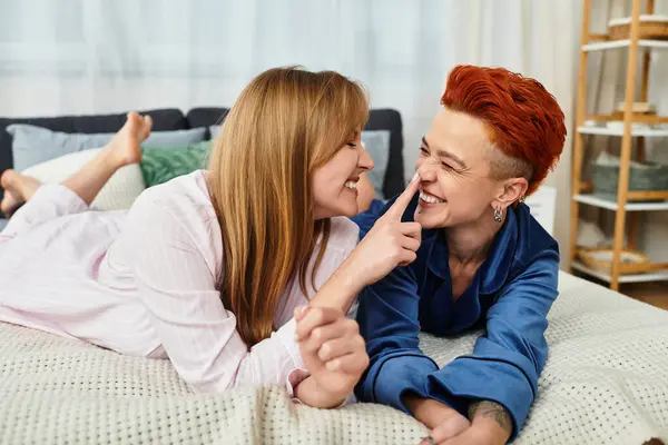 A joyful young couple shares a playful moment together in their stylish apartment, radiating love. — Stock Photo