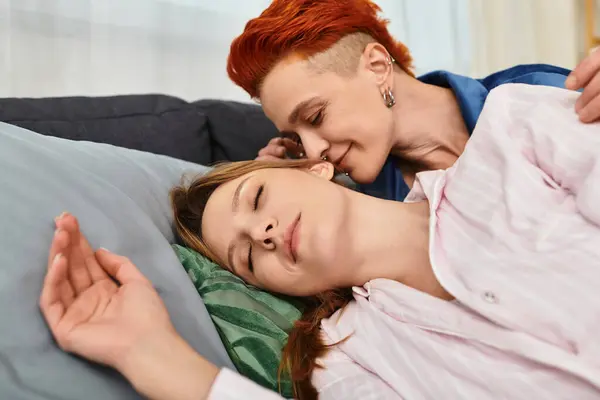 Two beautiful young women share a tender moment in their stylish apartment bedroom, basking in love. — Stock Photo