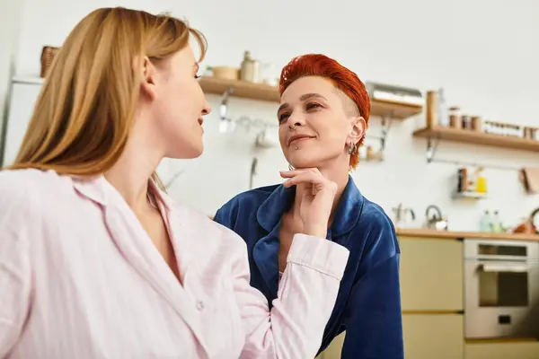 Two beautiful young women share tender moments in their modern room, surrounded by love. — Stock Photo