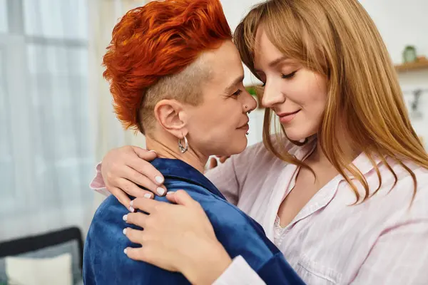 In a cozy bedroom, two young women share an intimate moment, embracing with love and joy. — Stock Photo
