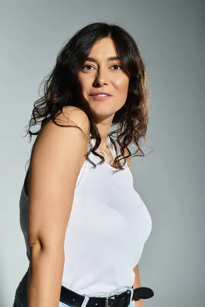 Abrazando la confianza, una hermosa mujer de tamaño grande posa en un estudio moderno. - foto de stock