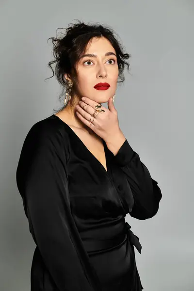 Captivating plus size woman showcases elegance in a stylish studio setting. — Stock Photo
