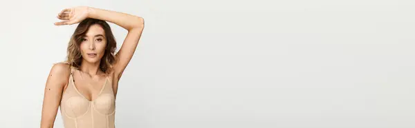 A young woman poses confidently in stylish lingerie, embodying modern fashion and beauty trends. — Stock Photo