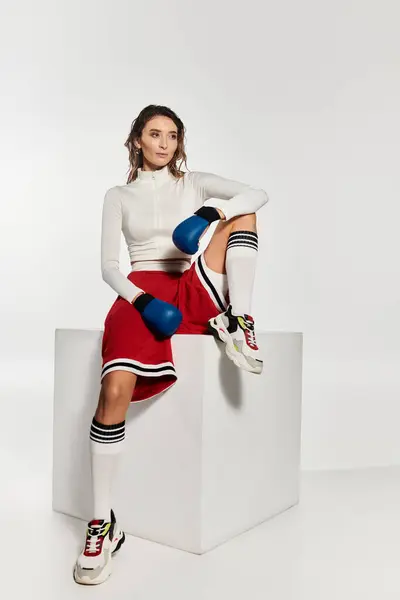 Young beautiful woman showcasing chic boxing style in contemporary fashion setting. — Stock Photo