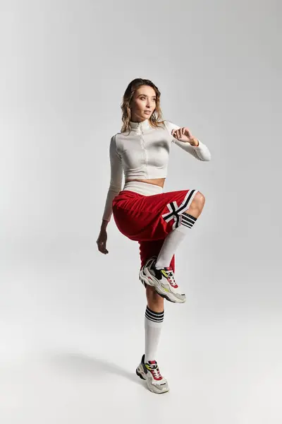 Chic young woman showcases sporty elegance in trendy streetwear attire during a fashion shoot. — Stock Photo