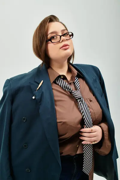 Giovane, bella plus size donna è elegantemente posato indossando un blazer alla moda oversize. — Foto stock