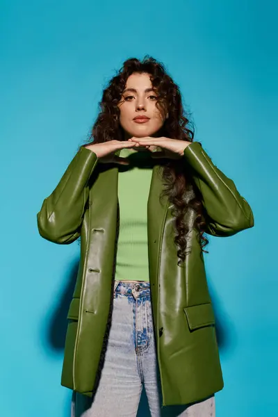 A fashionable young woman showcases her unique style with a bold green outfit and striking pose. — Stock Photo