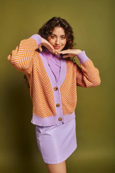 A beautiful young woman showcases her fashion sense with a playful pose in a colorful outfit. — Stock Photo