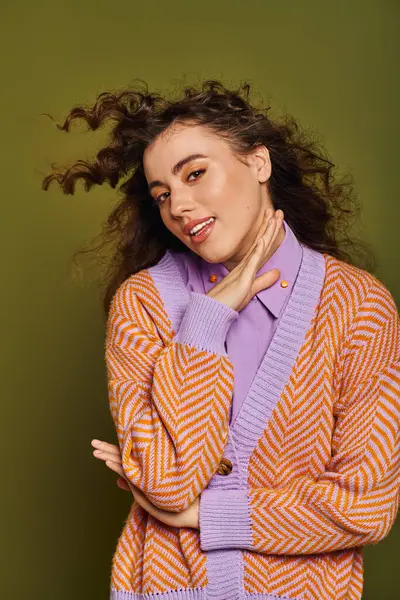 A beautiful young woman showcases her unique style, playfully posing as her hair dances in the air. — Stock Photo