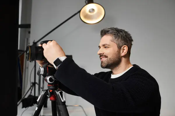 A skilled man sets up his camera to capture beautiful moments in bright lighting. — Stock Photo