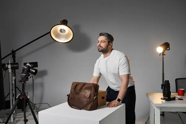 Un homme dévoué organise ses outils et son équipement dans un espace de travail contemporain, mettant l'accent sur la créativité. — Photo de stock