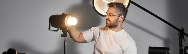 Una persona calificada ajusta las luces, preparándose para el trabajo artístico en un estudio animado. - foto de stock