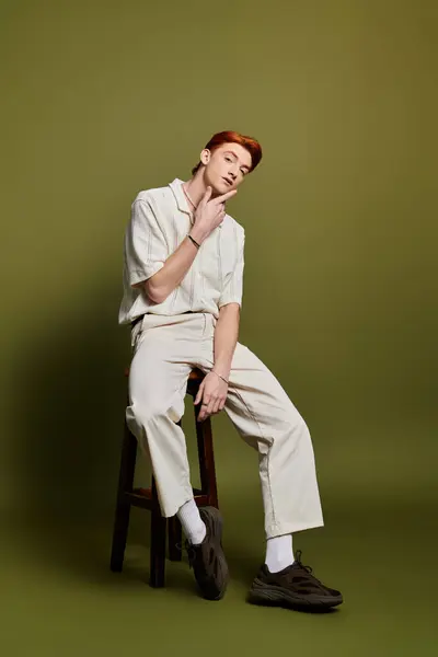 A young man with striking features conveys deep emotions in a minimalist studio. — Stock Photo