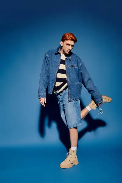A stylish young man poses with confidence, showcasing his denim outfit and emotional vibe. — Stock Photo