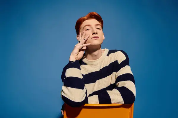 A young man with red hair poses thoughtfully, confidently expressing his emotions. — Stock Photo