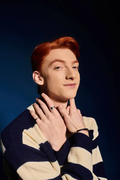 A young and handsome man with red hair gracefully poses, expressing emotions through his gaze. — Stock Photo