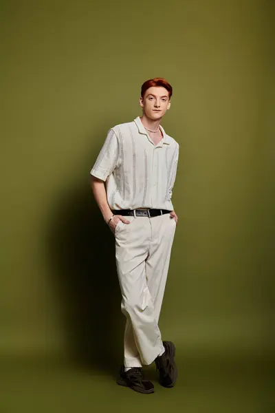 A handsome young man stands confidently, expressing deep emotions in a stylish outfit. — Stock Photo